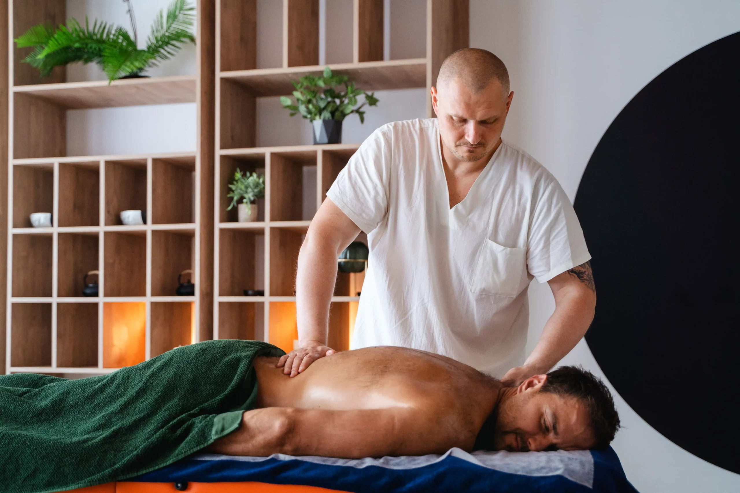 Active person receiving massage therapy for muscle recovery