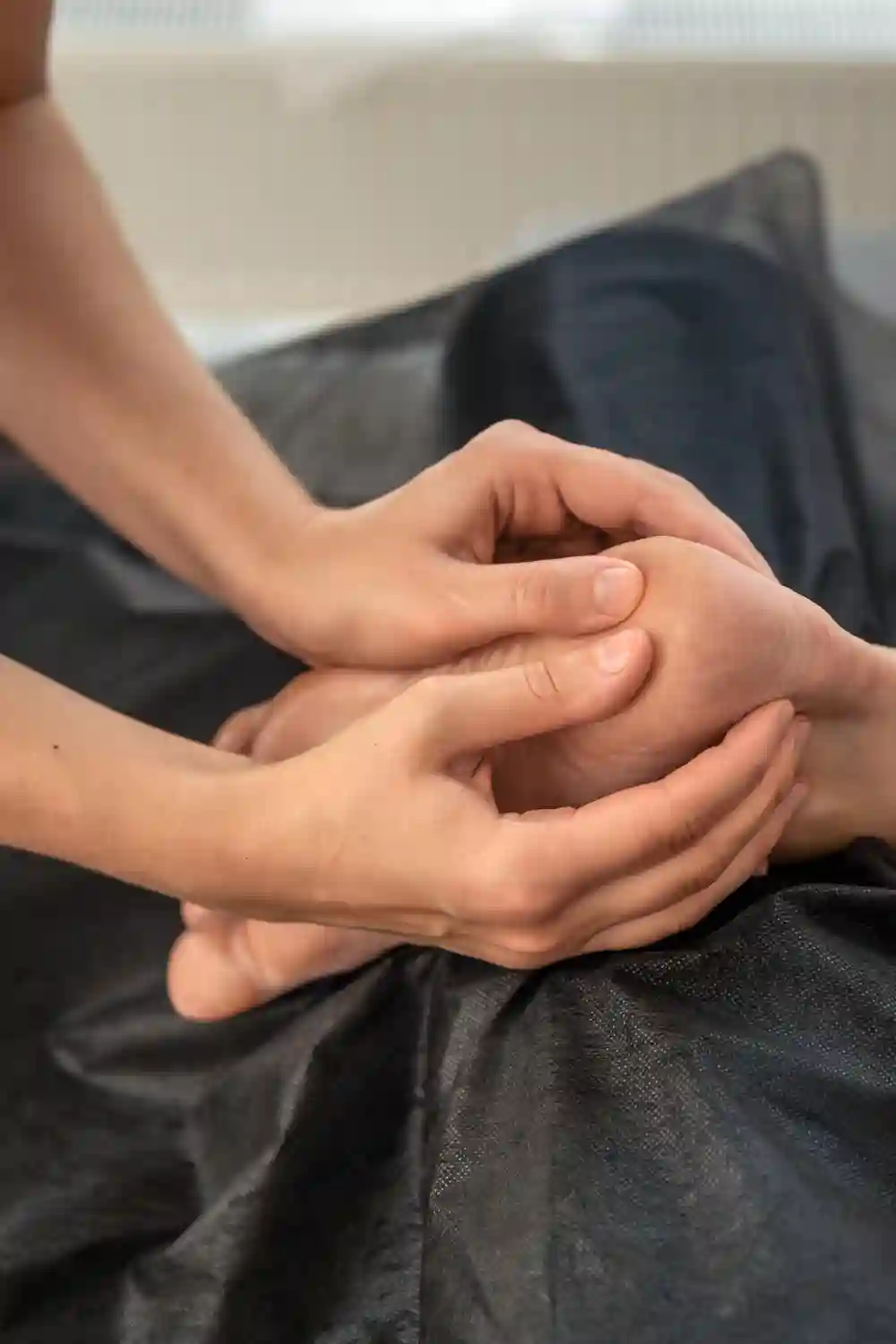 Therapist performing a gentle facial reflexology treatment