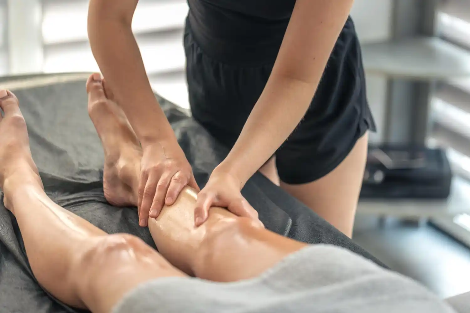 Professional massage therapist treating an active client