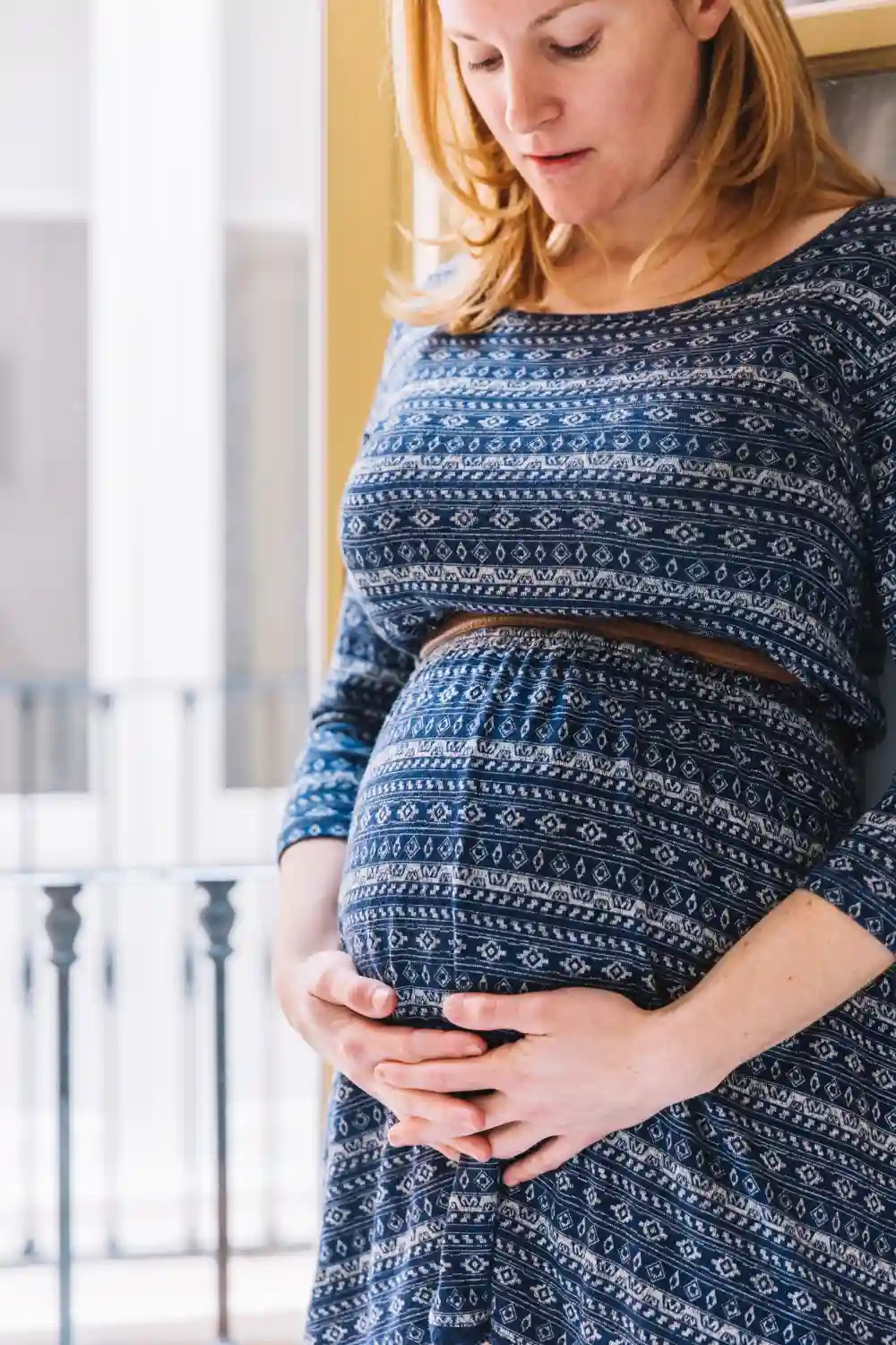 Therapist providing gentle lower back massage to a pregnant woman